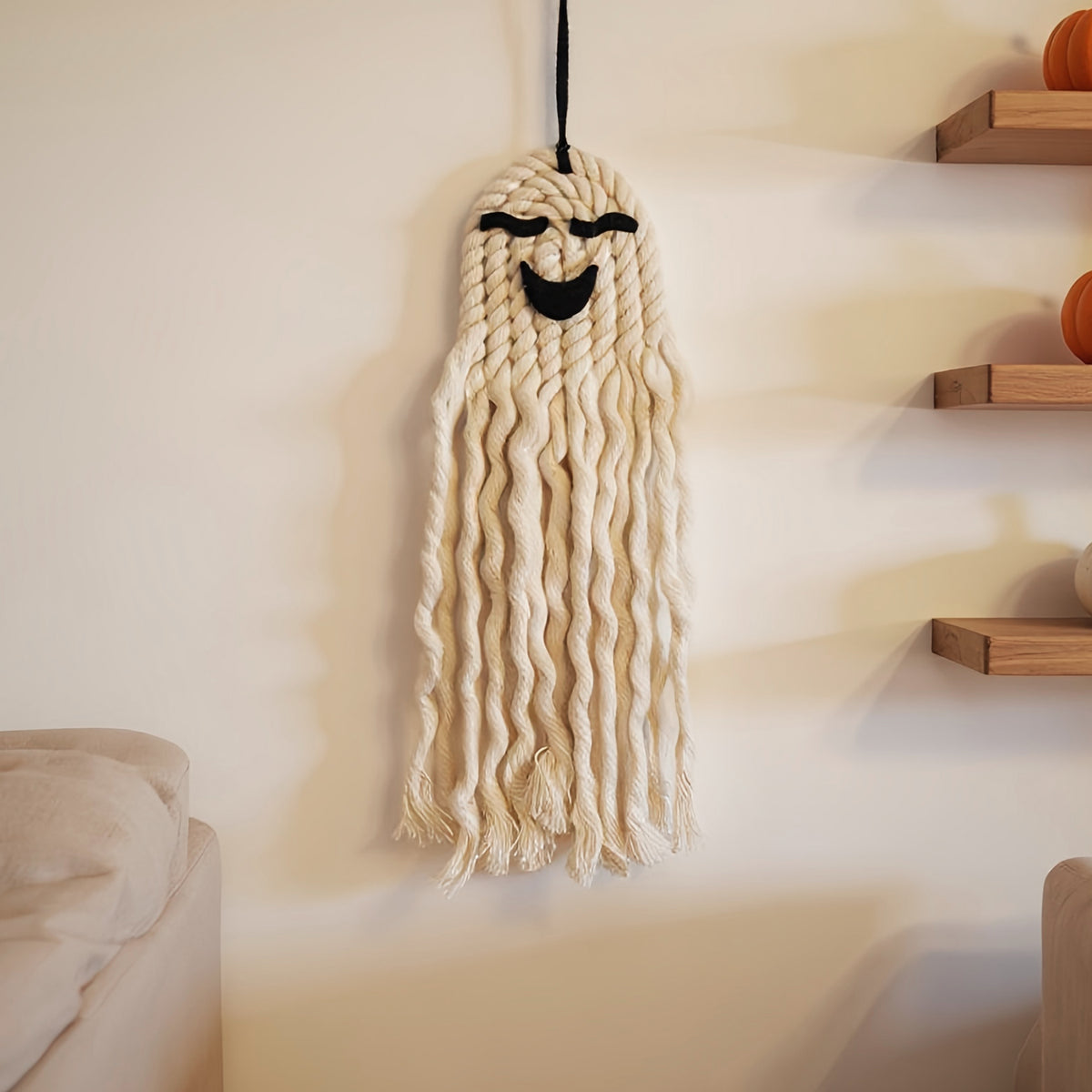 Artisan-crafted woven wall hanging featuring playful Halloween design – unique handmade fall ornament.