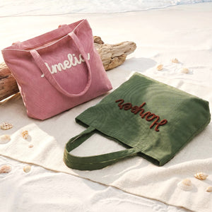 Color options for a personalized embroidered corduroy tote bag: navy blue, dark green, white, brown and pink